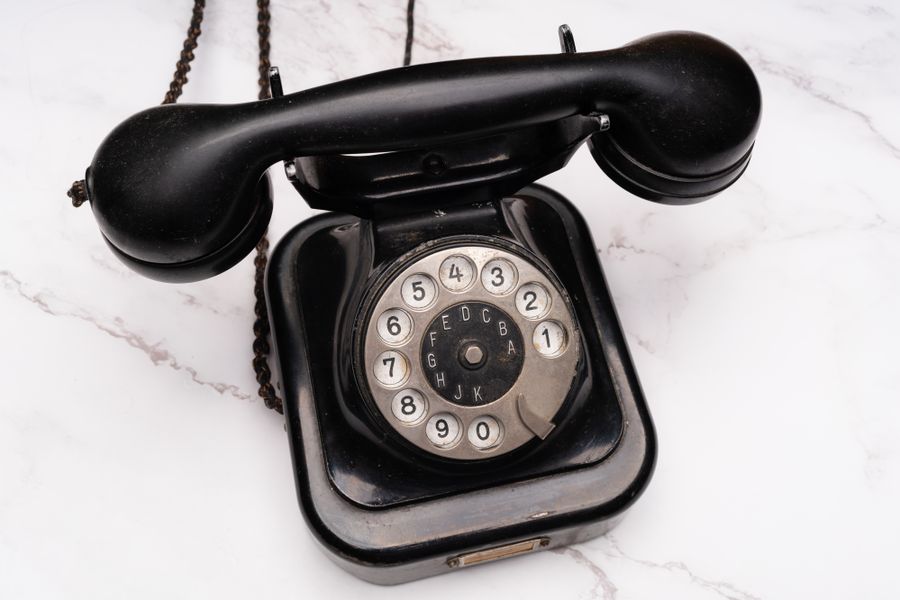 A vintage rotary telephone on a marble surface, standing in for the AI receptionist that answers when you can't.